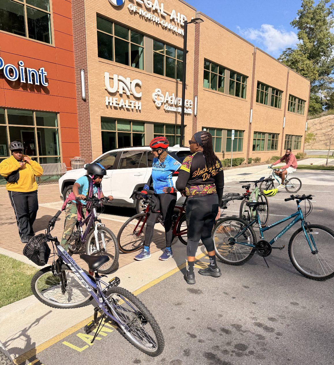 Riders gather with Black Girls Do Bike leaders before the community ride